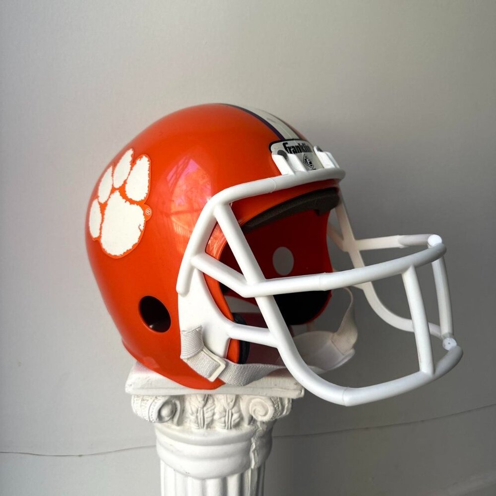 Orange and white Clemson Tigers helmet helmet Clemson University College
